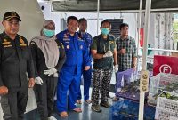 Petugas Karantina Sulawesi Tenggara, Polairud Polri, dan instansi terkait berfoto bersama saat pengamanan ratusan burung endemik hasil penggagalan penyelundupan di perairan Pelabuhan Kendari, Sabtu (24/1/2026).